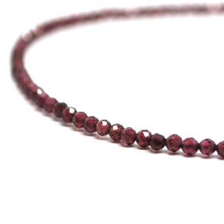 A rhodolite garnet microbead necklace against a white background