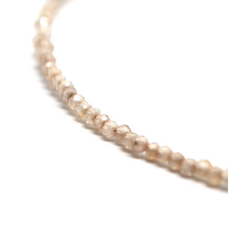 A zircon microbead necklace against a white background