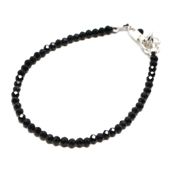 A black tourmaline microbead bracelet with a sterling silver lobster claw clasp against a white background