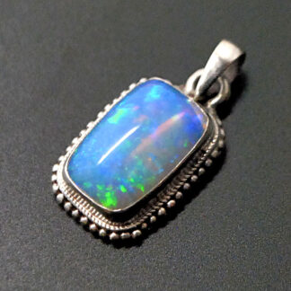 A square sterling silver pendant featuring an Ethiopian opal against a black background