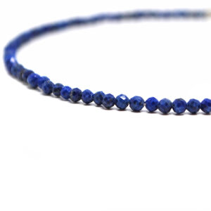 A lapis lazuli microbead bracelet against a white background