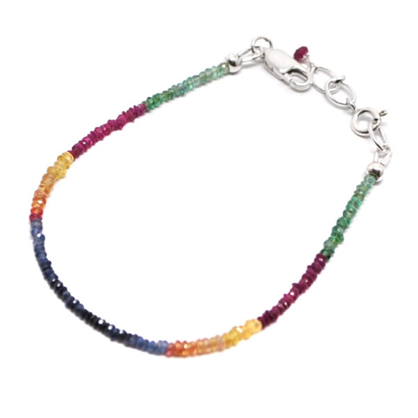 A ruby, emerald, and sapphire microbead bracelet with a sterling silver lobster claw clasp against a white background