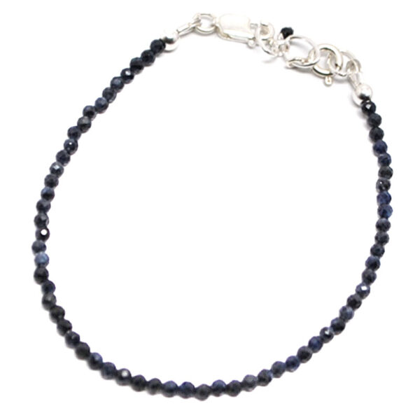 A dark blue sapphire microbead bracelet with a sterling silver lobster claw clasp against a white background