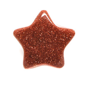 A goldstone star carving against a white background