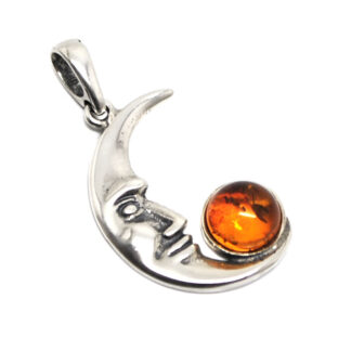 A sterling silver moon face pendant featuring a round amber cabochon against a white background