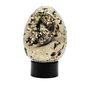 A carved pyrite egg with exposed crystals on a black acrylic ring stand against a white background