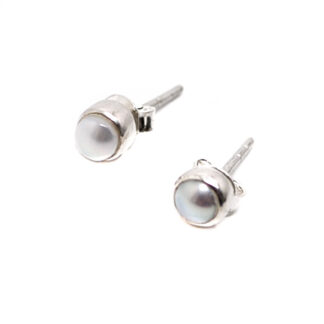 A pair of sterling silver stud earrings featuring pearls against a white background
