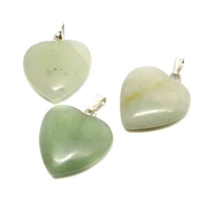 Three small light green jade carved heart pendants against a white background