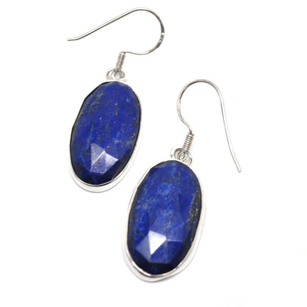A pair of oval lapis lazuli sterling silver earrings against a white background