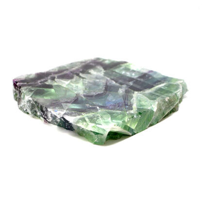 A rainbow fluorite slab with bright green and deep purple tones polished on both faces against a white background