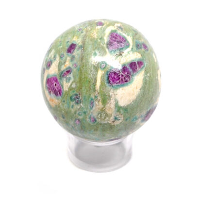 A fuchsite sphere with ruby crystal inclusions against a white background