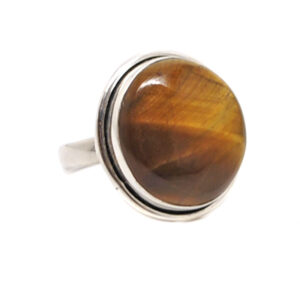 An oval tiger's eye cabochon set into a simple sterling silver ring against a white background