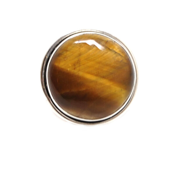 An oval tiger's eye cabochon set into a simple sterling silver ring against a white background