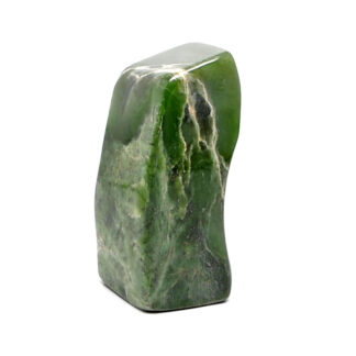A polished free form nephrite jade specimen against a white background