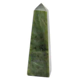 A cut and polished nephrite jade tower against a white background