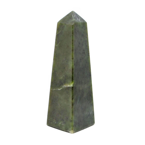 A cut and polished nephrite jade tower against a white background
