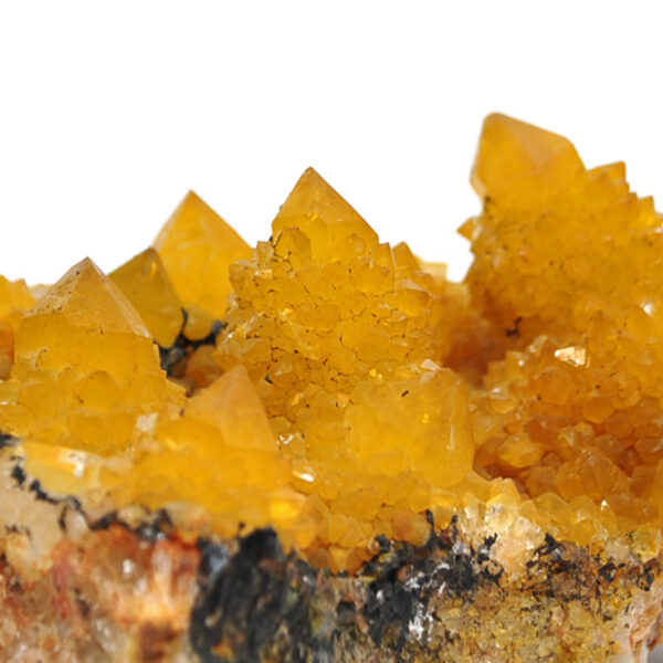 A golden healer spirit quartz crystal cluster against a white background