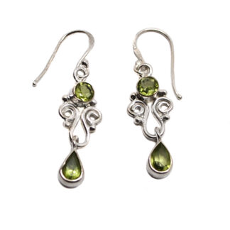 A pair of ornately designed sterling silver earrings featuring oval and teardrop faceted peridot gemstones against a white background
