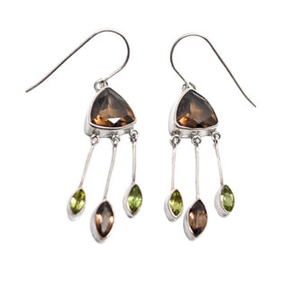 A pair of unique sterling silver dangle earrings featuring a trilliant faceted smokey quartz at the top with faceted smokey quartz and peridot gemstones attached to the bottom against a white background