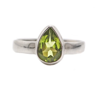 a ring with an teardrop faceted peridot set in sterling silver