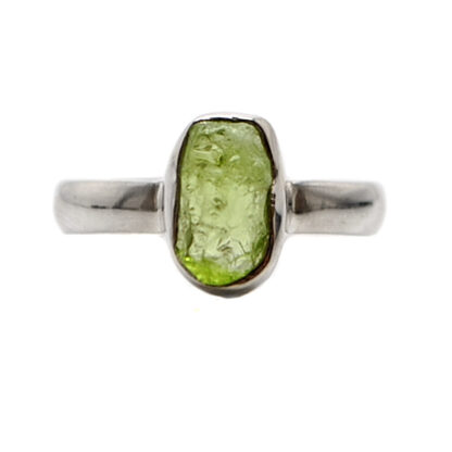 a ring with a rough piece of peridot set in sterling silver