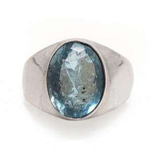 Blue Topaz Oval Faceted Sterling Silver Ring with a thick band against a white backround.