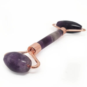 Amethyst face roller against a white backround