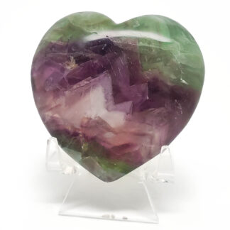 Rainbow Fluorite Heart on a clear stand against a white backround.
