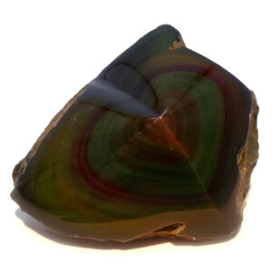 Rainbow Obsidian Heart under a direct spot light against a white backround.