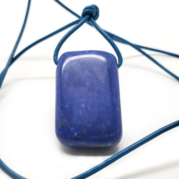 A Lapis Lazuli Drilled Pendant with a teal leather rope against a black background