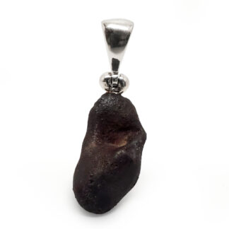 Meteorite Rough Pendant photographed behind a white background