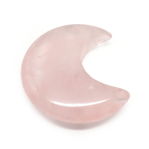 A carved rose quartz moon cresent against a white background